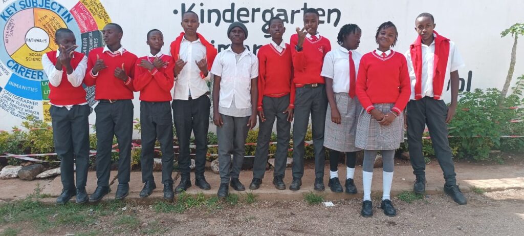 Eldema Letap Academy students posing for a photo at the school entrance